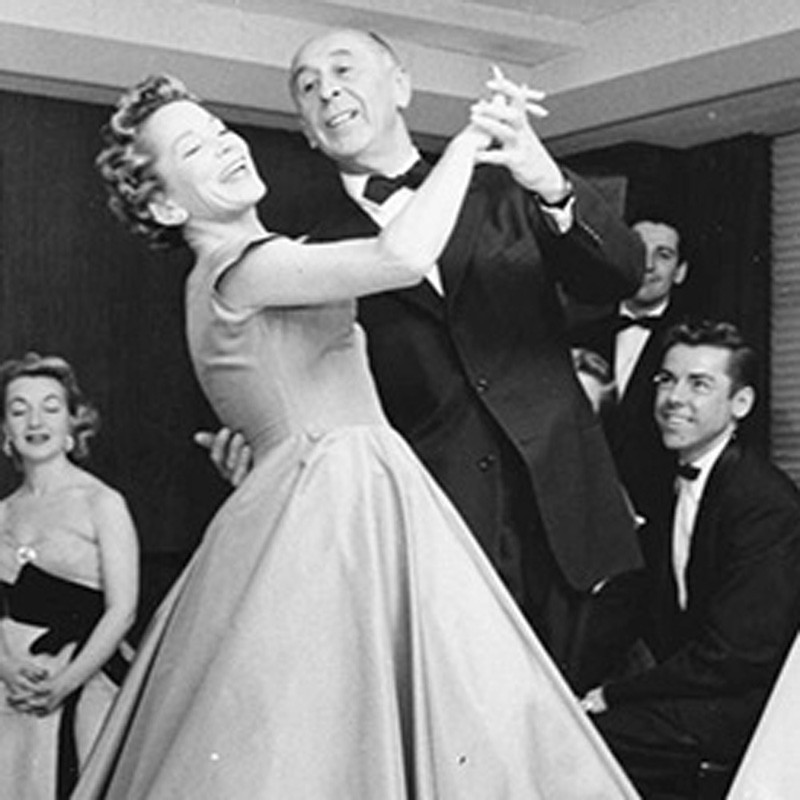 A man and woman in formal attire dancing together at the Dance Center in Gainesville, FL.