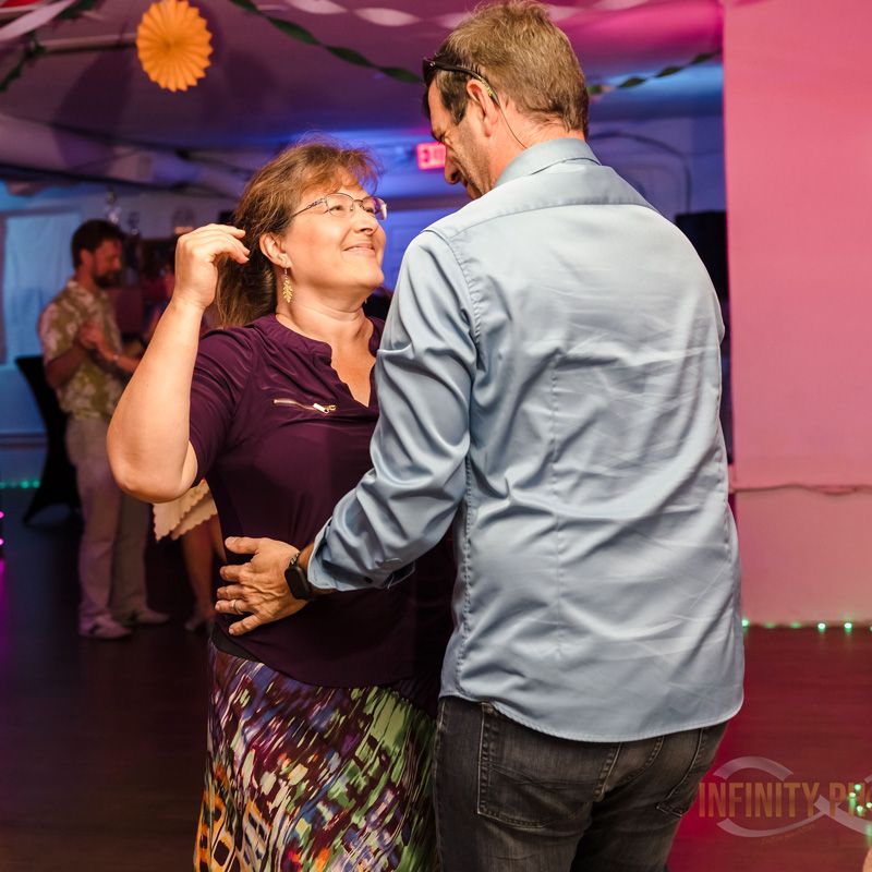 A couple dancing at a party, capturing the group dance classes offered in Gainesville, FL.
