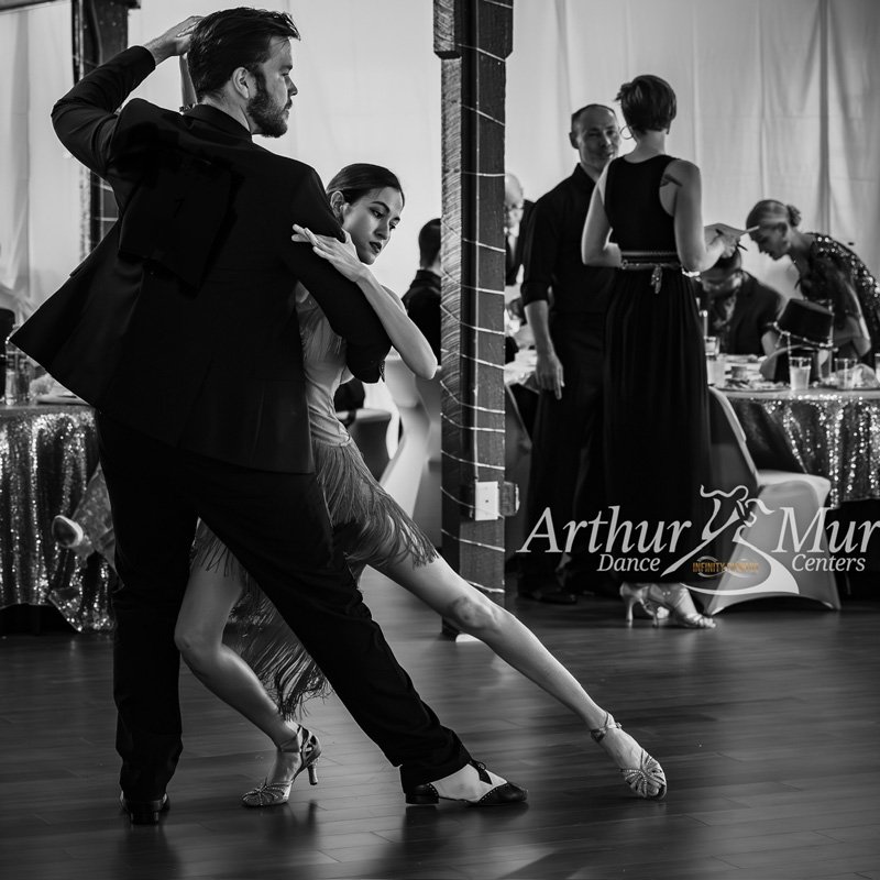 A couple performing a graceful tango at a formal dance event exudes elegance in Gainesville, FL