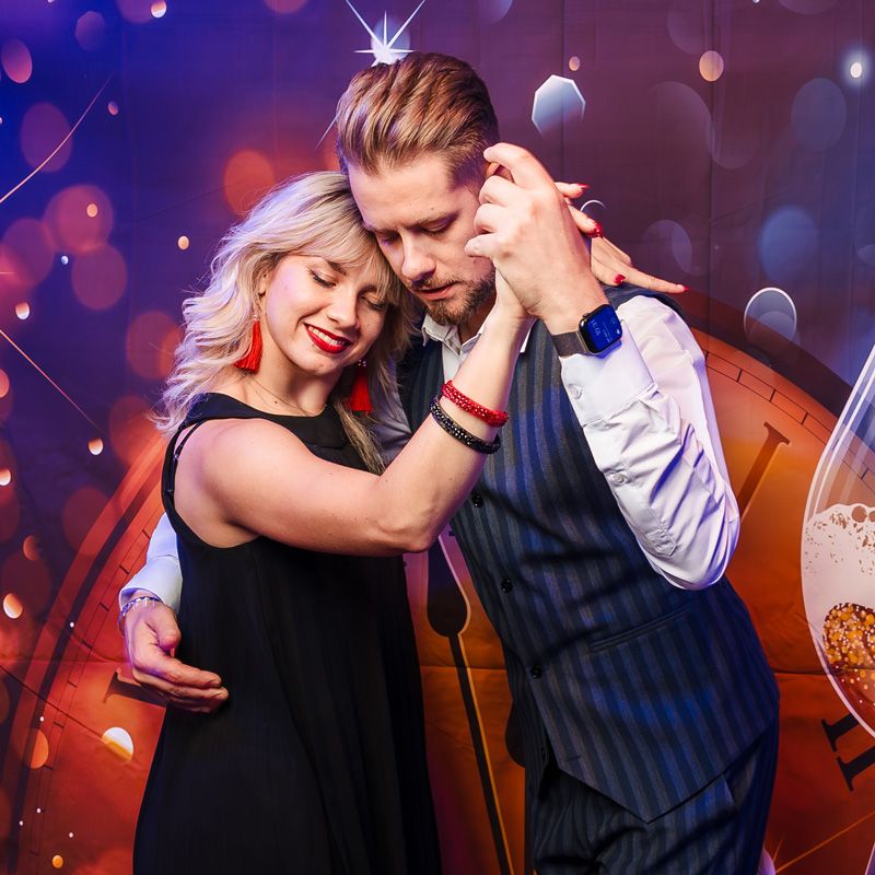 A couple showcases their tango moves under festive lights, spreading joy in Gainesville, FL