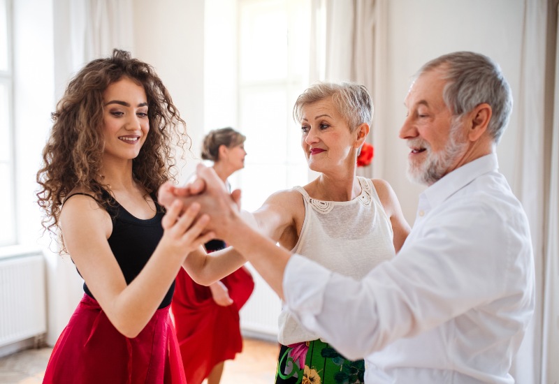 Adults practicing dance with an instructor in a beginner dance lesson in Gainesville, FL