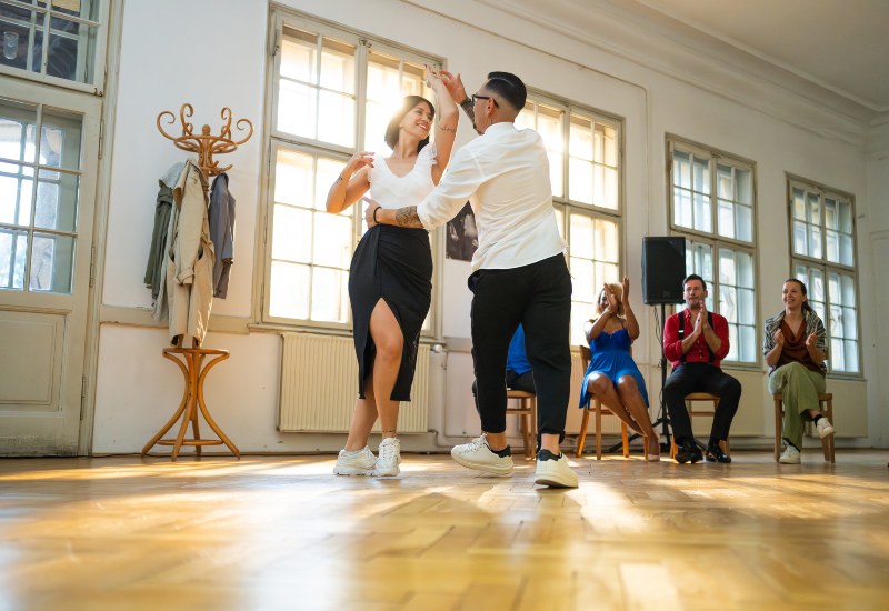 A couple practicing jazz dance in a bright studio in Gainesville, FL