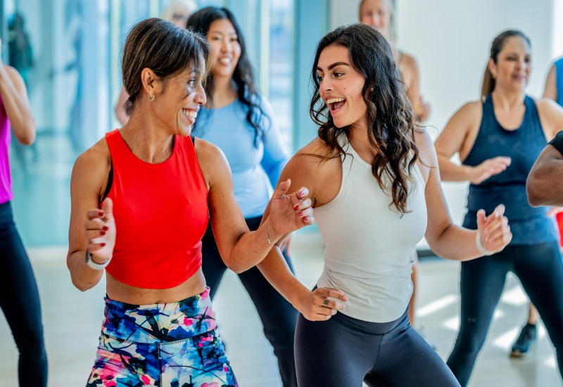 Group dancing in a studio demonstrating the benefits of strength and flexibility in Gainesville, FL